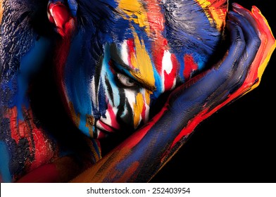 Man painted different colors. Body art colorful.