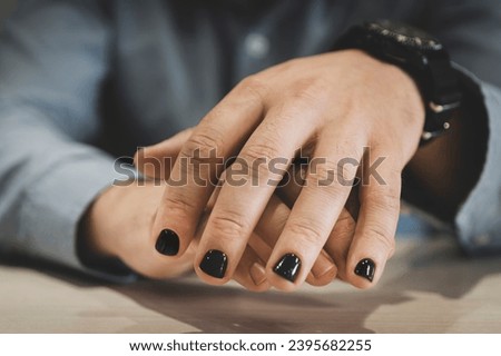 A man with painted nails. Design of male nails. men manicure. The nails are painted in a fashionable black color