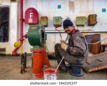 A Man Is Painting Air Vent Head Of Ballast Tank On A Cargo Ship