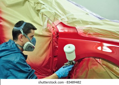 Man Painting A Red Car.