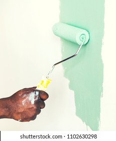 Man Painting The Wall Green