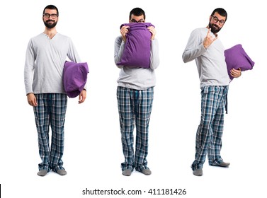 Man In Pajamas Hiding Behind His Pillow