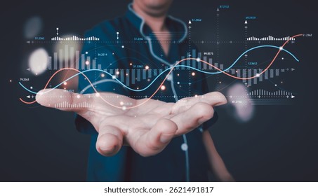 Man in pajamas holding out a hand with glowing holographic financial graphs, charts, and data visualizations, symbolizing data analysis, investment, and digital finance.