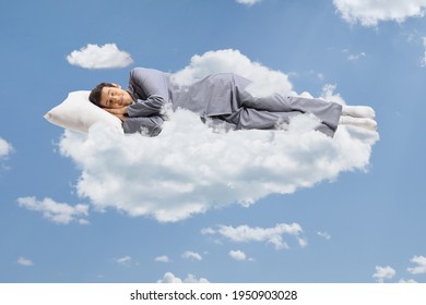 Man In Pajamas Sleeping On A Cloud And Floating In The Sky