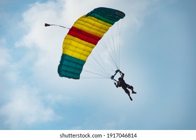 A Man With Parachute Floating In The Sky