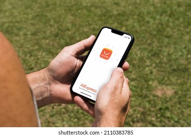 Man In The Park Holding A Smartphone With Ali Express App On The Screen. Rio De Janeiro, RJ, Brazil. January 2022.