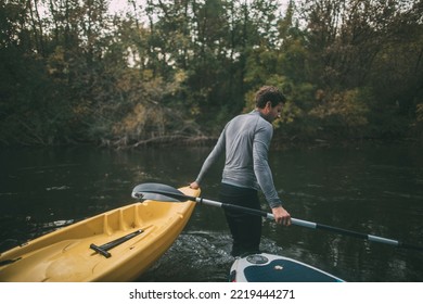 Man Pass The Kayak Across River Rapids