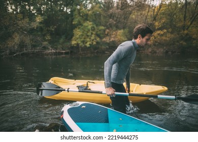 Man Pass The Kayak Across River Rapids