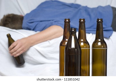 Man Passed Out With A Beer Bottle In His Hand. Alcohol Abuse