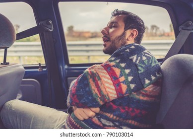 Man Passenger Sleeping In The Backseat Of A Car On A Trip 