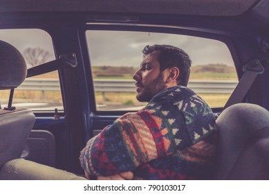 Man Passenger Sleeping In The Backseat Of A Car On A Trip 