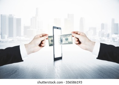 A Man Passes Another Man Money Through Smartphone, Online Money Transfer Concept