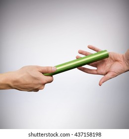 Man Passing The Baton To Partner On Track