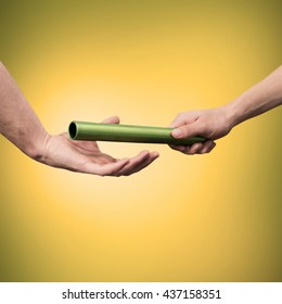Man passing the baton to partner on yellow background