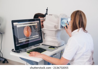 man patient has eye examination. digital retina scanner