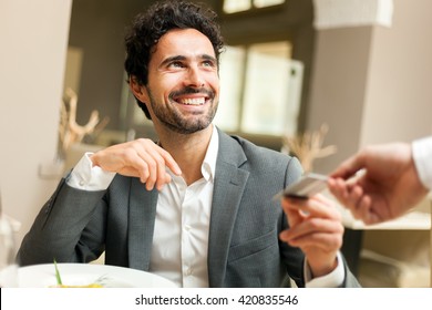 Man paying the bill with a credit card