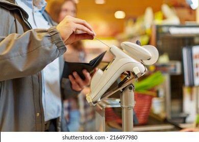 Man Paying With Credit Card At Supermarket Checkout