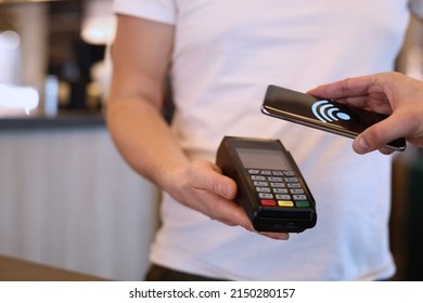 Man Paying With Mobile Phone Over Pos Terminal With Nfc Technology