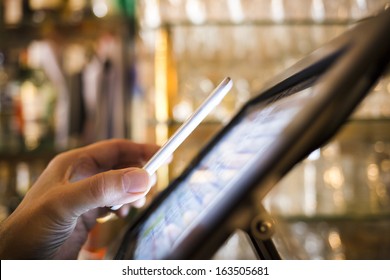 Man Paying With NFC Technology On Mobile Phone, In Restaurant, Bar, Cafe