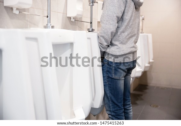 A Man Peeing To The Toilet Bowl In The Restroom 0734