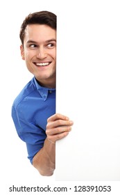Man peeping over blank poster