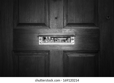 man-peeping-through-letterbox-black-260nw-169120214.jpg