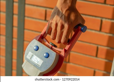 Man Perform The Hand Grip Strength Testing With Hand Grip Dynamo Meter To Measure Physical Fitness Of The Forearm