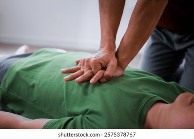 A man performing CPR on another man lying down, placing his hands on the patient’s chest to ensure safety, monitor heart rate, provide emergency services, and maintain health care and body integrity