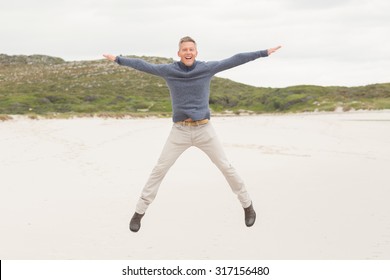 Man Performing A Jumping Jack At The Beach