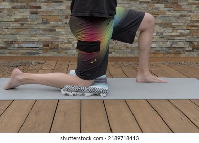 A Man Performing A Low Lunge Stretch