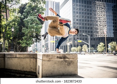 Man performing parkour tricks in the urban center - Powered by Shutterstock