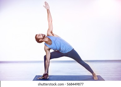 Man Performing Yoga In Gym