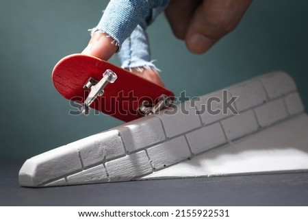 A man performs exercises with a fingerboard on a plaster ramp
