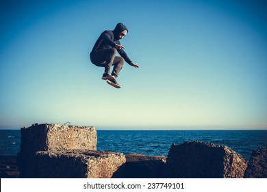 Man Performs Freerunning Jump On Stones