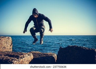 Man Performs Freerunning Jump On Stones