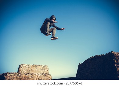 Man Performs Freerunning Jump On Stones