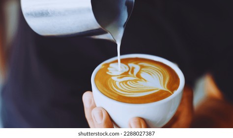 a man person making latte art in a cup of coffee. - Shutterstock ID 2288027387