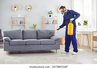 Man from the pest control service diligently sprays insecticide on the sofa in the living room at home, effectively eliminating insects and ensuring a bug free and clean environment. - Powered by Shutterstock