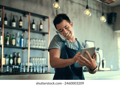 Man, phone call and waiter in restaurant talking, tablet and typing for online review and inventory order for business. Communication, planning and information search, sales and contact suppliers - Powered by Shutterstock