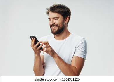 A man with a phone in his hands is an internet technology communication service - Powered by Shutterstock