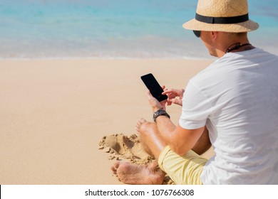 Man With Phone On The Beach