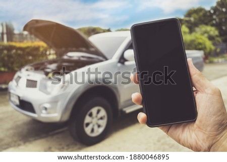 Man Phoning For Help with a broken down car