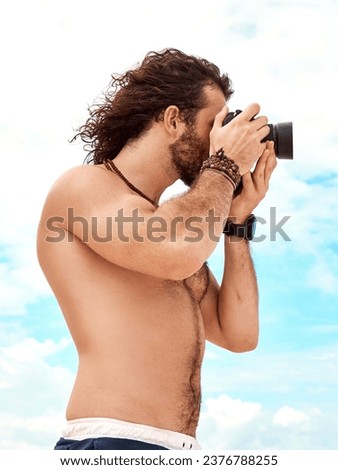 Man, photographer and camera with blue sky and clouds in summer for photo or picture in nature outdoors. Shirtless male person in photography for memory, tourist or holiday weekend pictures outside