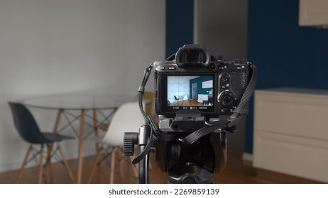 Man photographer taking pictures indoor in living room - real estate home photography and professional video to sell the house apartment - interior design and home staging