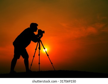 Man Photographer Taking Pictures Silhouette Concept - Powered by Shutterstock