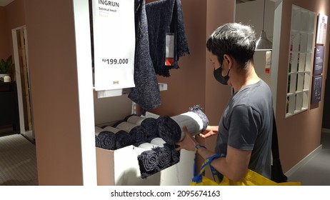 A Man Pick Up A  Wool Blanket. IKEA, Jakarta, 24 December 2021