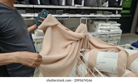 A Man Pick Up A  Wool Blanket. IKEA, Jakarta, 24 December 2021