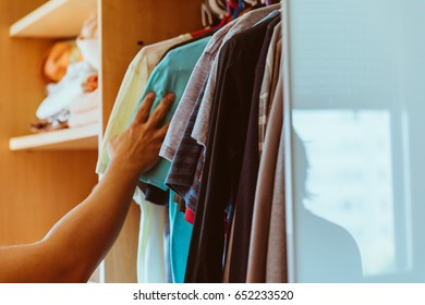 Man Picking Clothes From The Closet