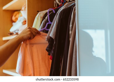 Man Picking Clothes From The Closet