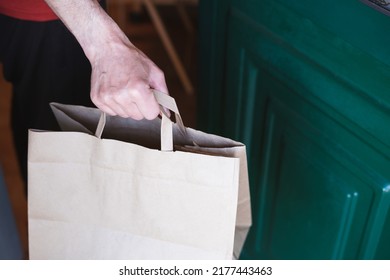 Man Picking Up A Paper Bag At The Door Of His House. Online Shopping. Home Delivery.